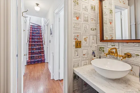 a bathroom with a granite countertop sink toilet a mirror and shower