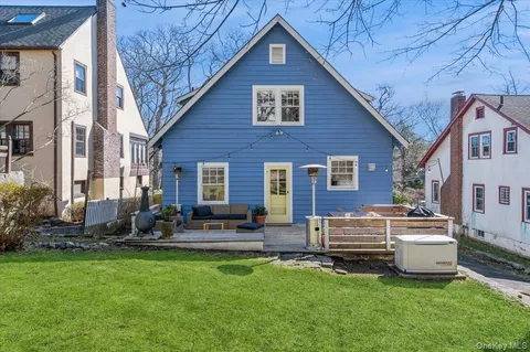a front view of a house with patio and garden