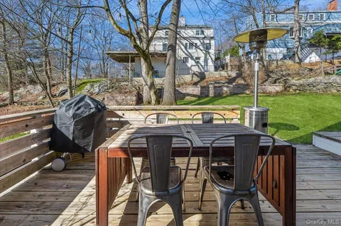 a view of a chairs and table in patio with a yard