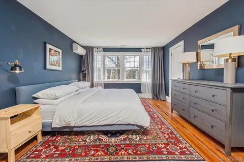 a bedroom with a bed and a dresser in it