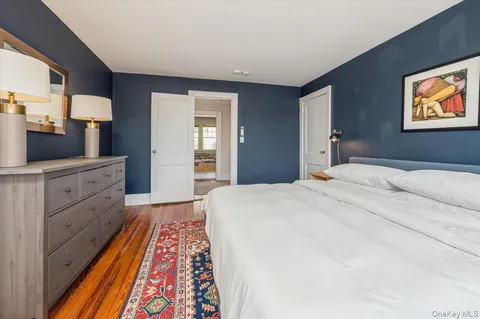 a bedroom with a bed and a dresser in it