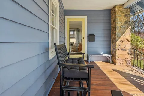 a balcony with table and chairs