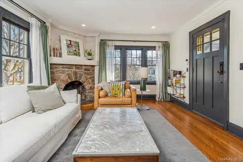 a living room with furniture large window and a fireplace