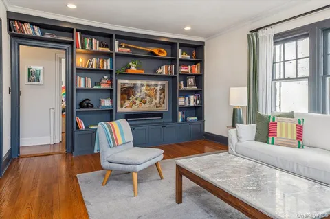 a living room with furniture and a book shelf
