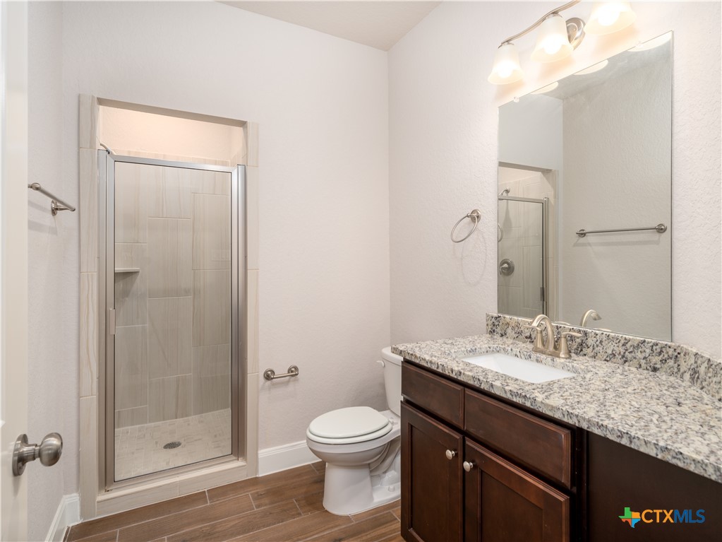 109 High Drive Spring Branch, TX 78070 - Photo 3 of 20 a bathroom with a granite countertop sink toilet and shower