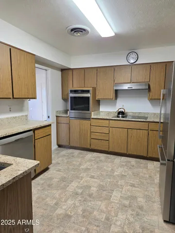 a kitchen with cabinets a sink and a stove