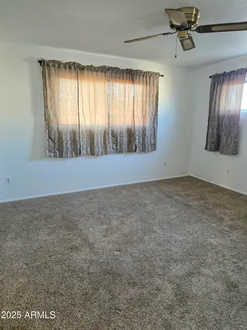 an empty room with windows and closet