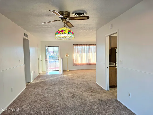 an empty room with windows and closet