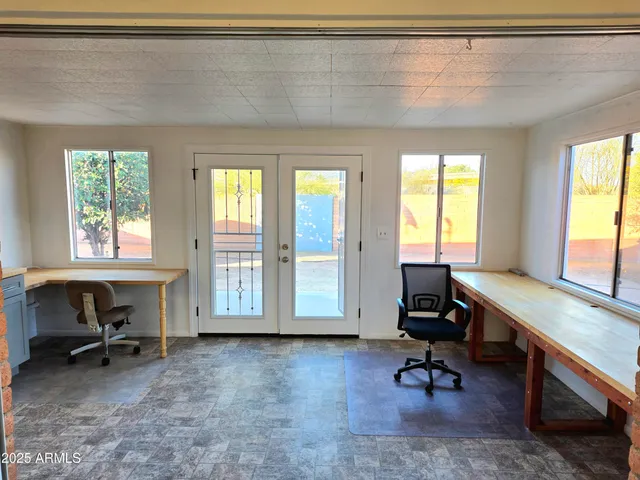 a view of a livingroom with workspace and a window