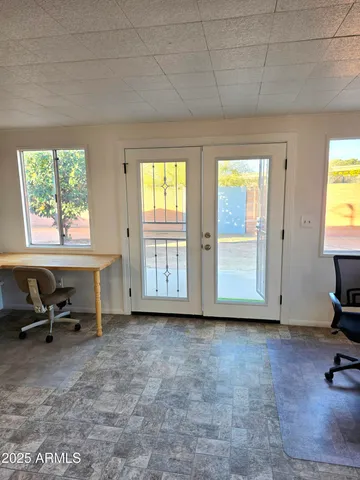 a view of a room with gym equipment and a window