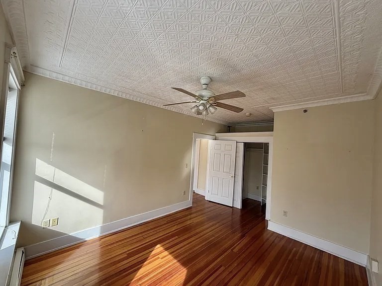27 High Street, Unit 1 Clinton, MA 01510 - Photo 6 of 30 a view of an empty room with wooden floor and a window
