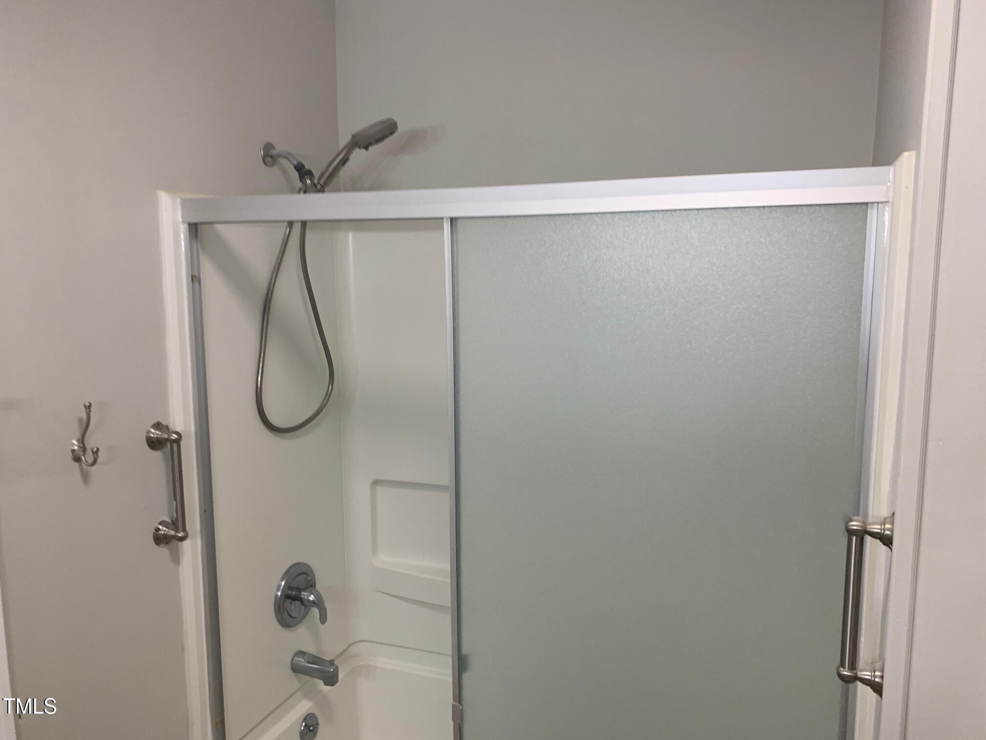 209 Reade Drive Roxboro, NC 27573 - Photo 11 of 19 a bathroom with a glass shower door