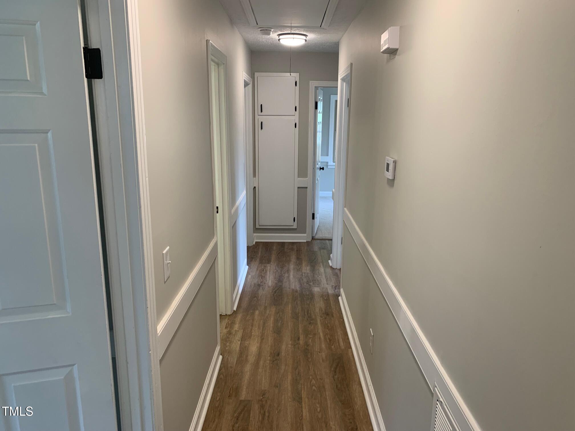 209 Reade Drive Roxboro, NC 27573 - Photo 14 of 19 a view of a hallway with wooden floor and staircase