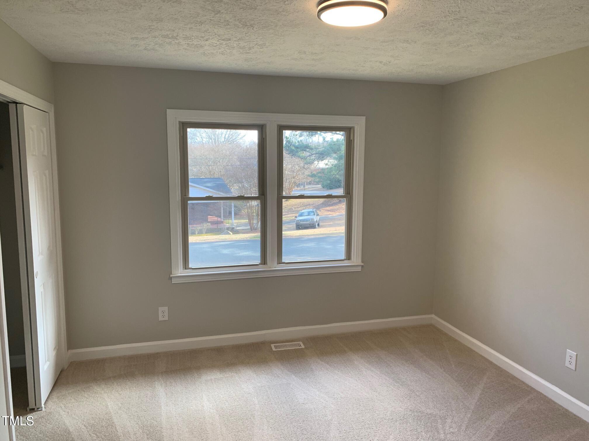 209 Reade Drive Roxboro, NC 27573 - Photo 16 of 19 an empty room with a window