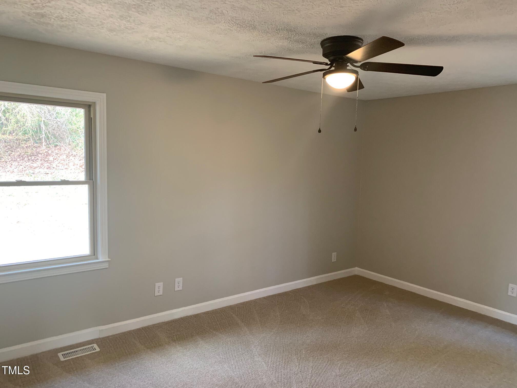 209 Reade Drive Roxboro, NC 27573 - Photo 17 of 19 an empty room with a window