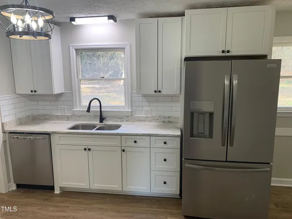 a kitchen with cabinets and stainless steel appliances