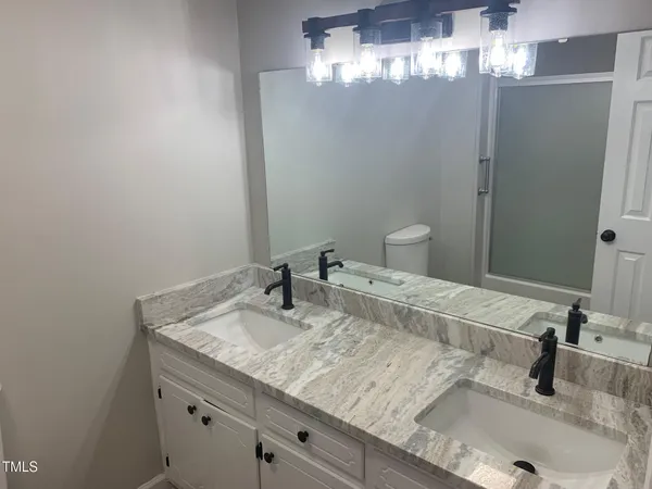 a bathroom with a sink and vanity