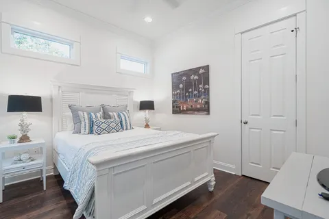 a living room with furniture a flat screen tv and a window