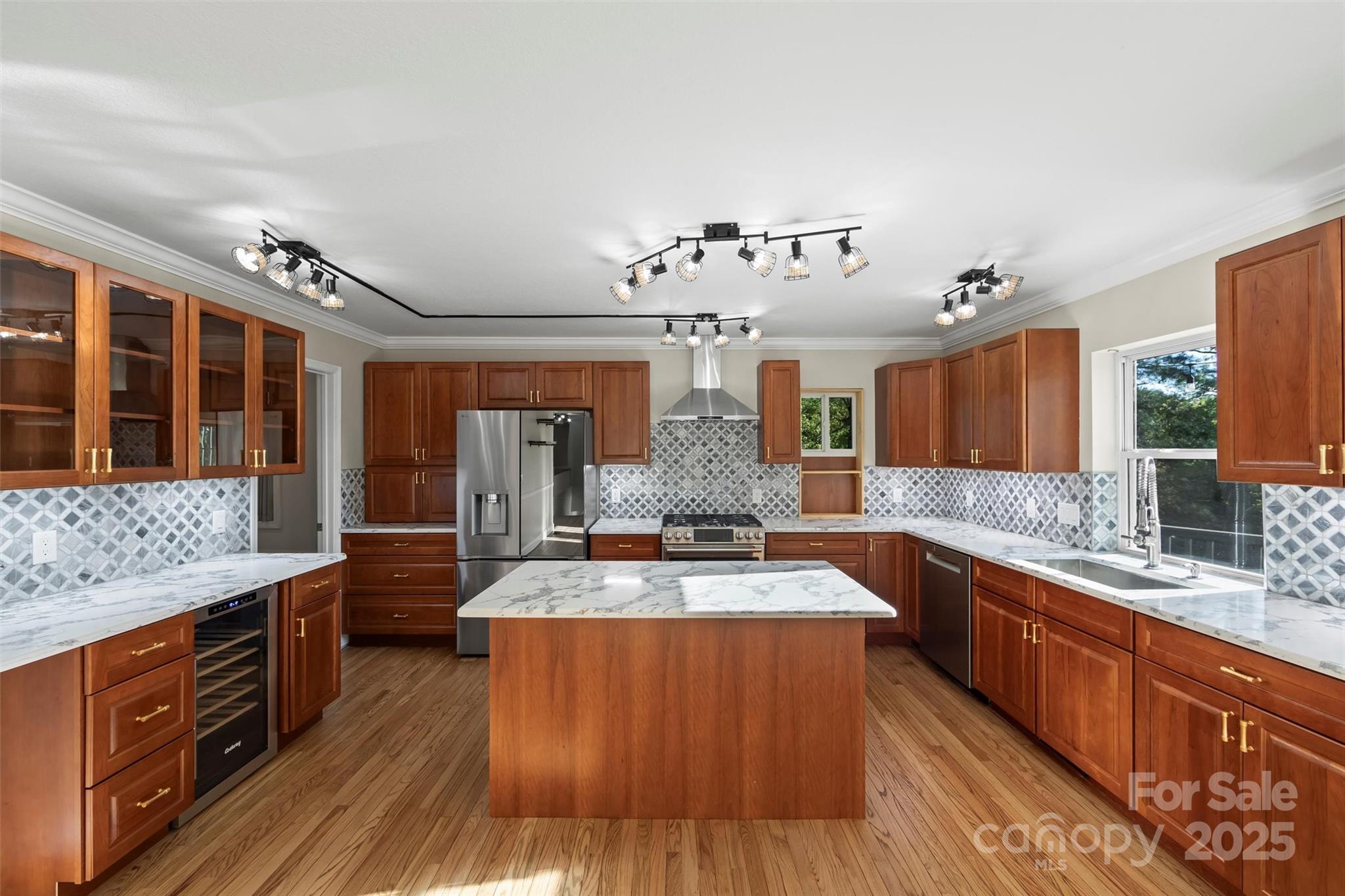 84 Halfmoon Way Clyde, NC 28721 - Photo 13 of 48 a large kitchen with stainless steel appliances granite countertop a large stove a sink dishwasher and cabinets with wooden floor
