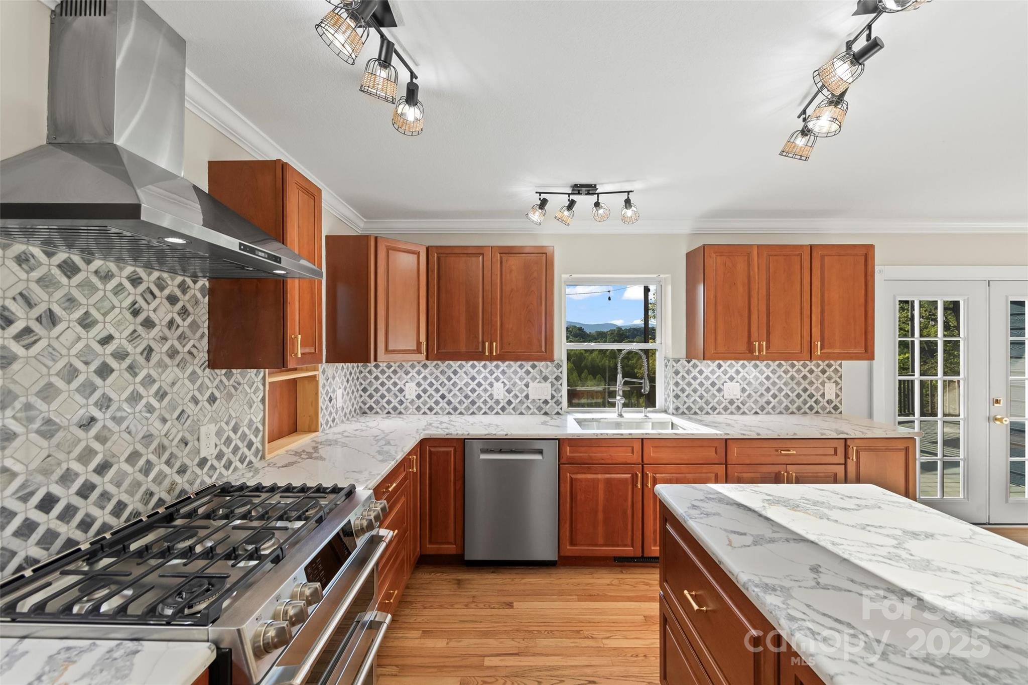 84 Halfmoon Way Clyde, NC 28721 - Photo 15 of 48 a kitchen with stainless steel appliances granite countertop a sink stove and cabinets