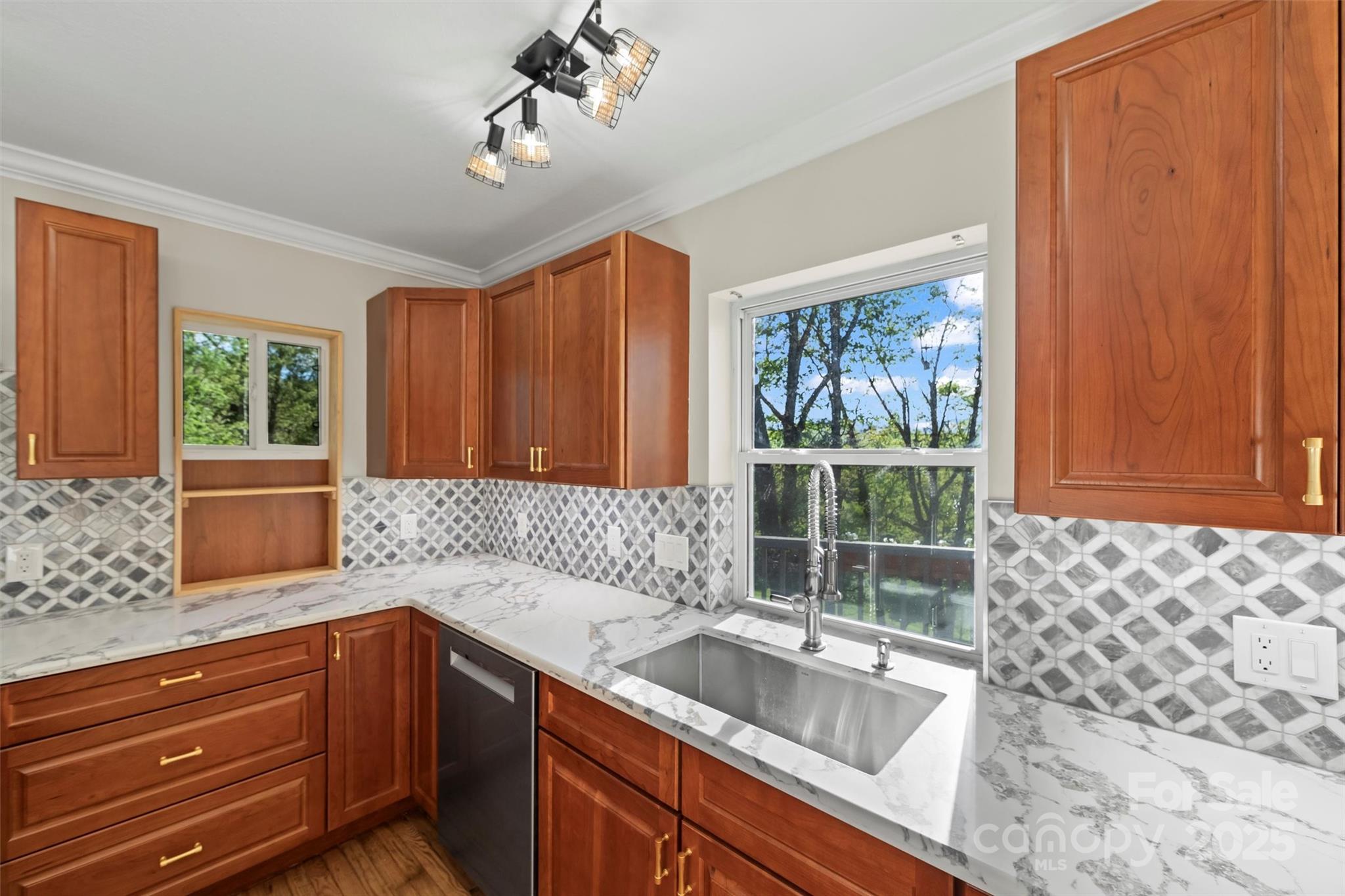 84 Halfmoon Way Clyde, NC 28721 - Photo 16 of 48 a kitchen with granite countertop a sink window and cabinets