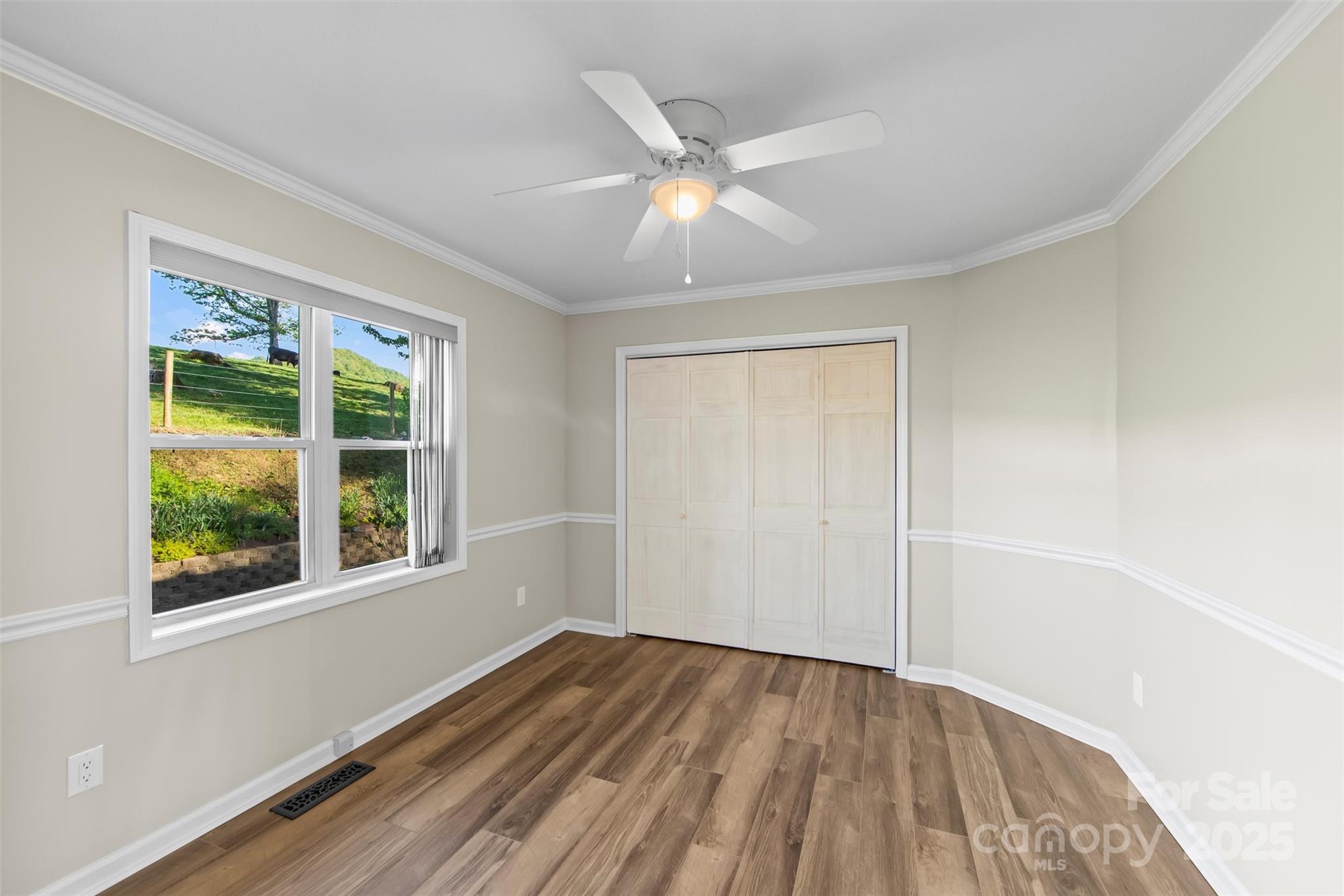 84 Halfmoon Way Clyde, NC 28721 - Photo 26 of 48 a view of an empty room with wooden floor and a window