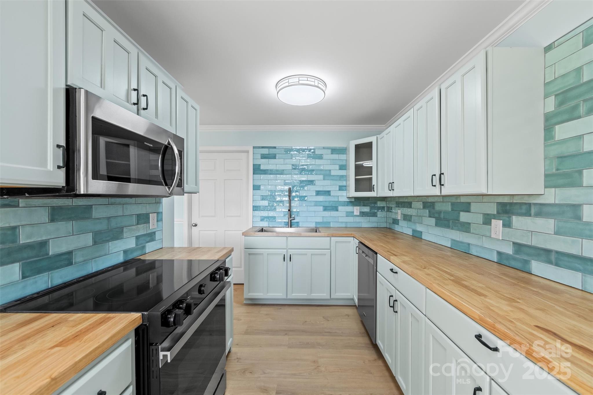 84 Halfmoon Way Clyde, NC 28721 - Photo 35 of 48 a kitchen with stainless steel appliances granite countertop a sink a stove top oven and granite counter tops