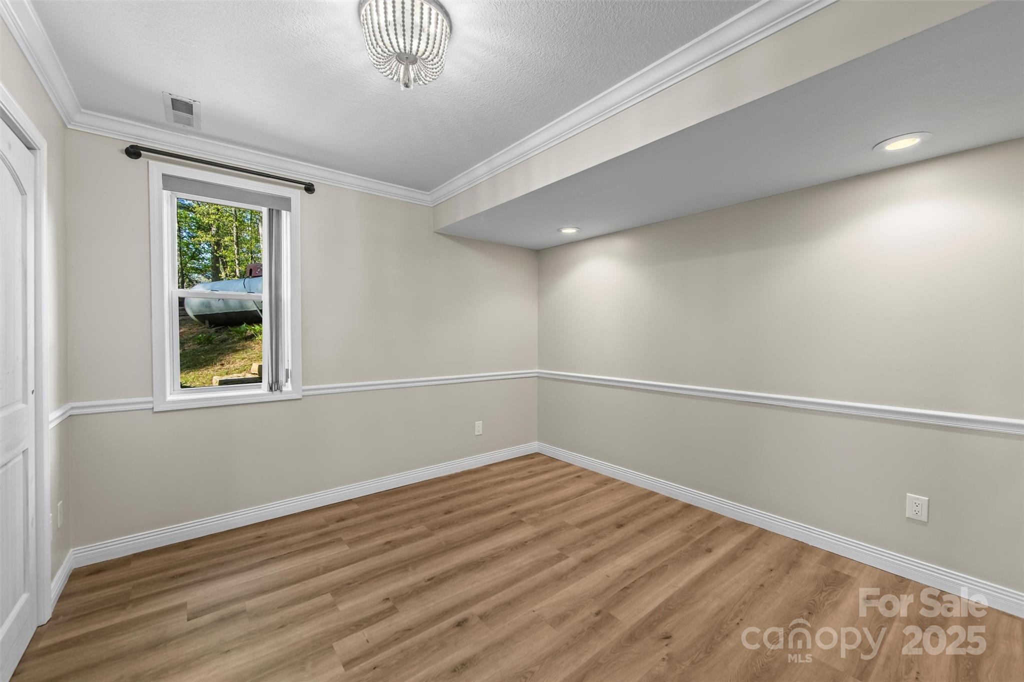 84 Halfmoon Way Clyde, NC 28721 - Photo 38 of 48 wooden floor in an empty room with a window