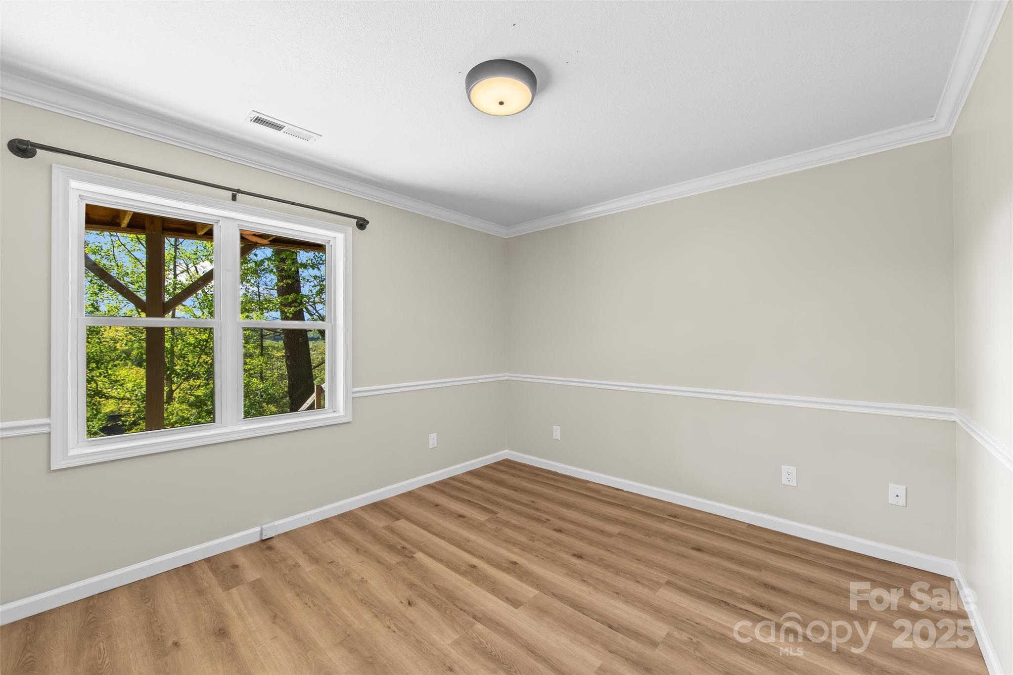 84 Halfmoon Way Clyde, NC 28721 - Photo 40 of 48 a view of empty room with wooden floor and fan