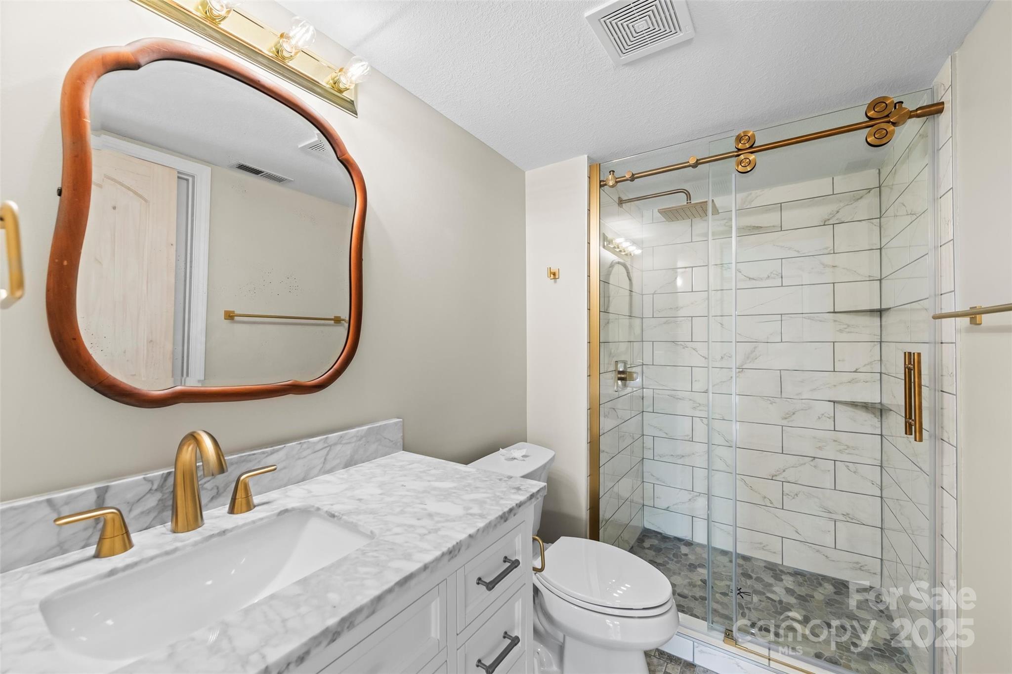 84 Halfmoon Way Clyde, NC 28721 - Photo 43 of 48 a bathroom with a sink a toilet and shower