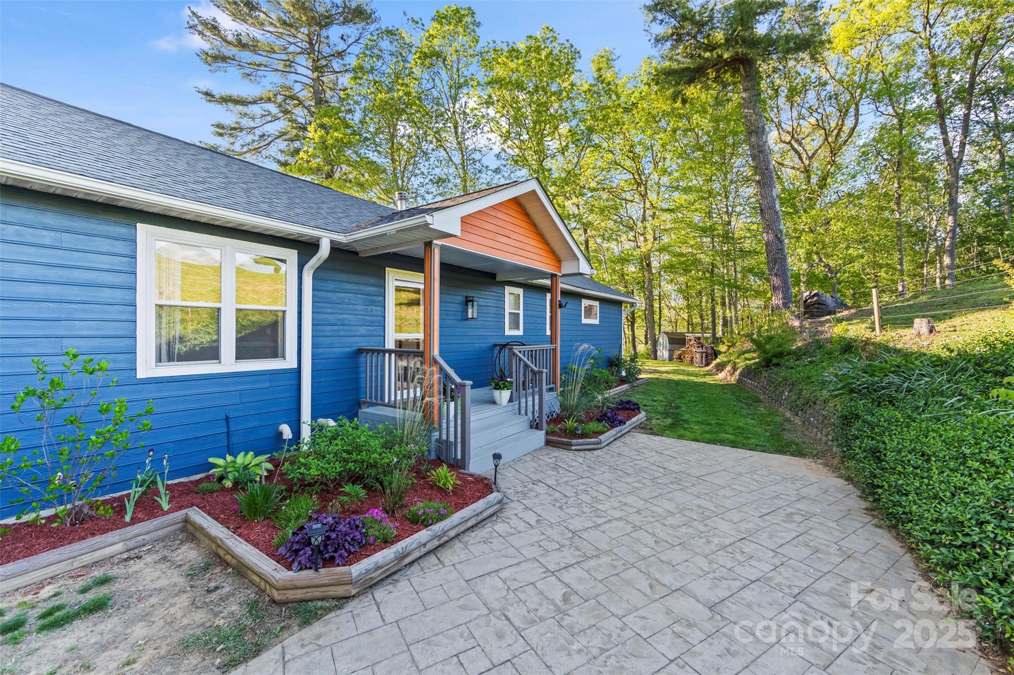 84 Halfmoon Way Clyde, NC 28721 - Photo 5 of 48 a front view of a house with garden