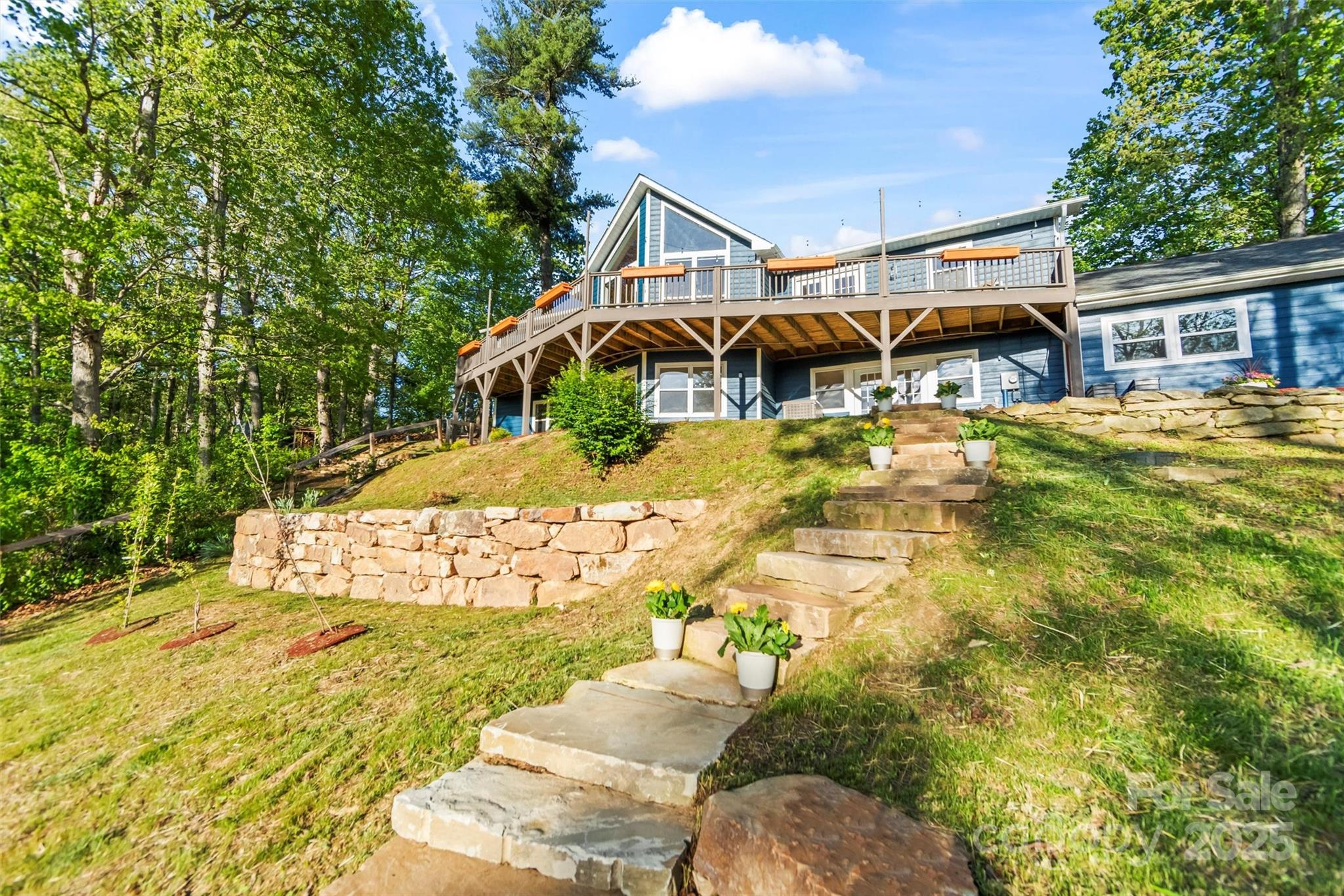 84 Halfmoon Way Clyde, NC 28721 - Photo 6 of 48 a front view of a house with a yard and a garage