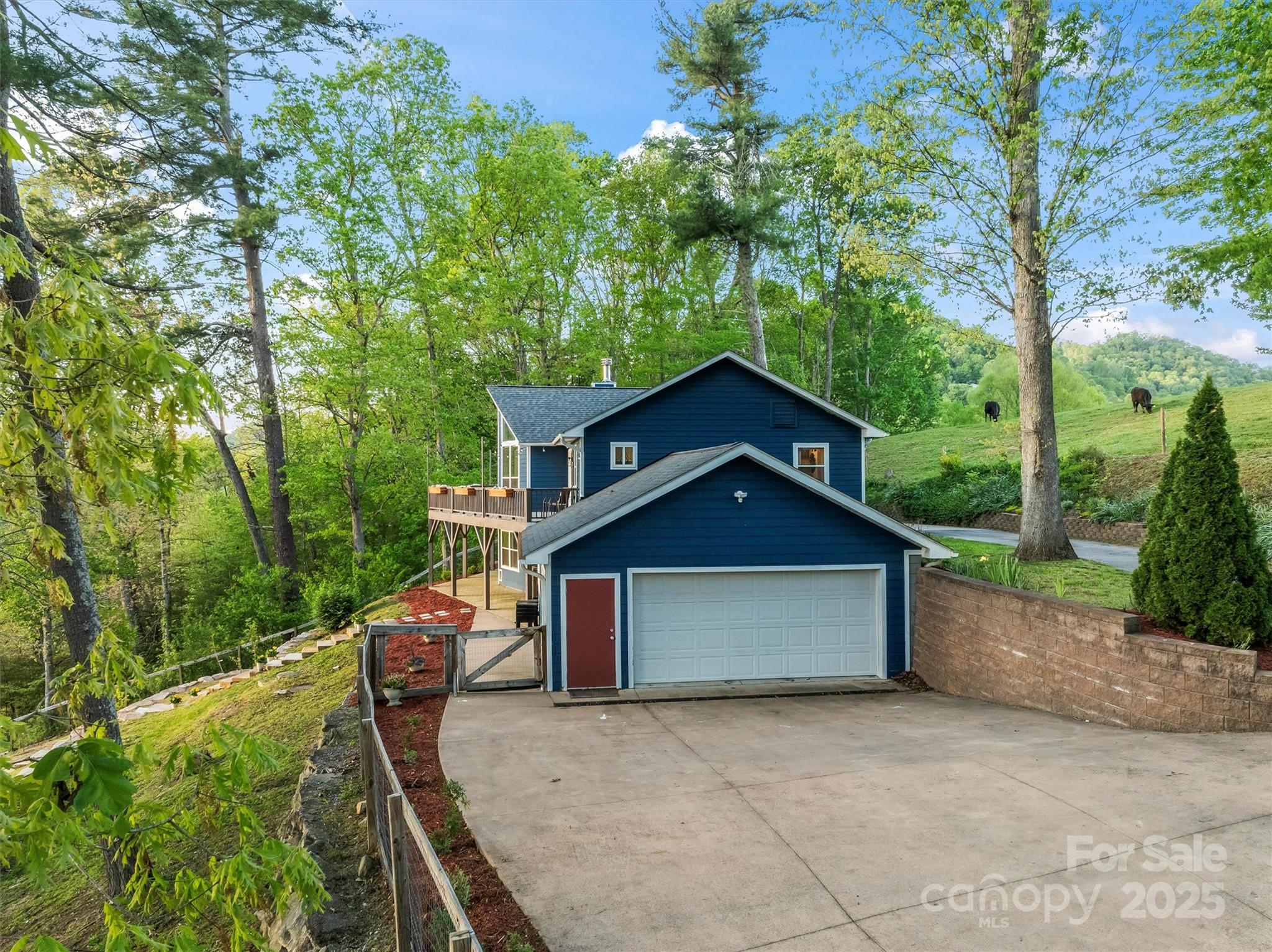 84 Halfmoon Way Clyde, NC 28721 - Photo 7 of 48 a front view of a house with garden