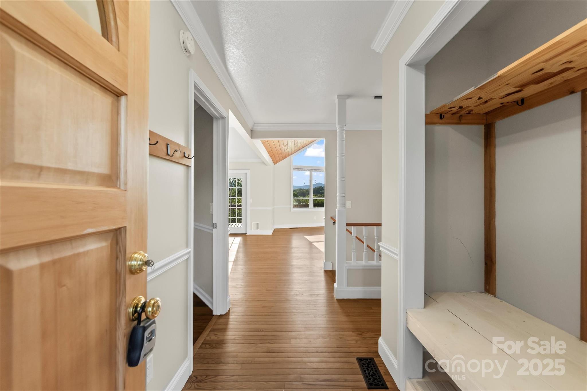 84 Halfmoon Way Clyde, NC 28721 - Photo 8 of 48 a view of a hallway with wooden floor and staircase