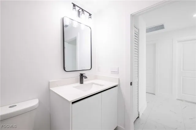 a bathroom with a sink toilet a mirror and shower
