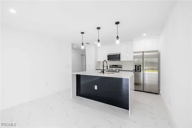 a view of a kitchen with a sink and cabinets
