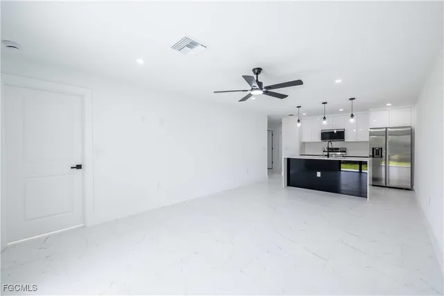 a kitchen with stainless steel appliances a refrigerator stove and microwave