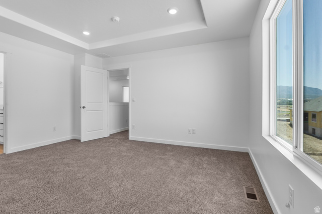 1355 West 2350 South, Unit 11 Perry, UT 84302 - Photo 31 of 39 Spacious room featuring a tray ceiling, recessed lighting, and large windows