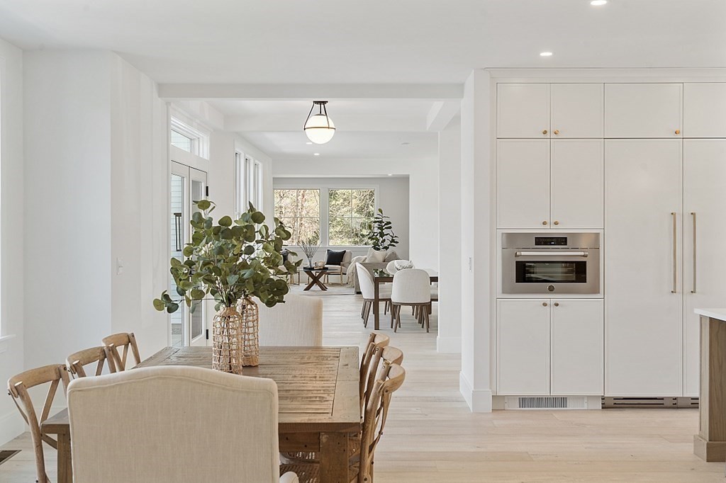 66 Spencer Brook Road Concord, MA 01742 - Photo 12 of 37 a living room with furniture a chandelier and a flat screen tv