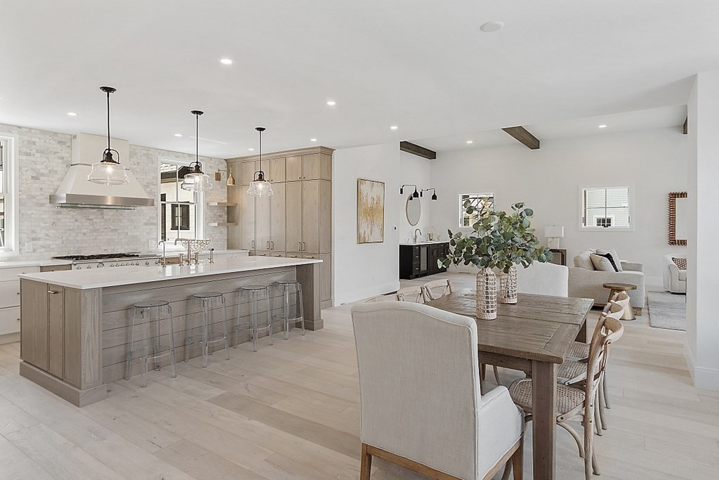 66 Spencer Brook Road Concord, MA 01742 - Photo 7 of 37 a kitchen with kitchen island granite countertop a table and chairs in it