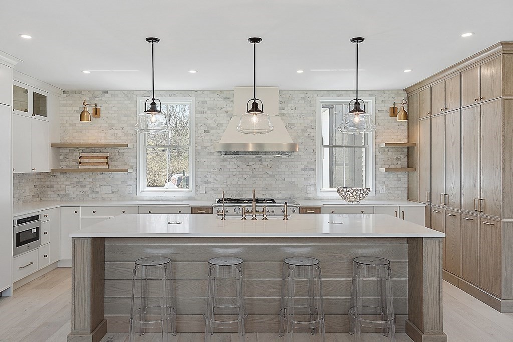 66 Spencer Brook Road Concord, MA 01742 - Photo 8 of 37 a kitchen with stainless steel appliances granite countertop a sink a island a stove a refrigerator and white cabinets