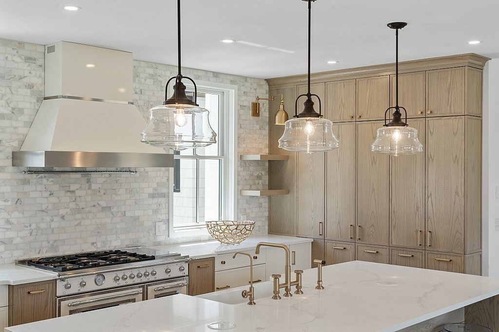 66 Spencer Brook Road Concord, MA 01742 - Photo 9 of 37 a kitchen with stainless steel appliances granite countertop a sink a stove a refrigerator and island