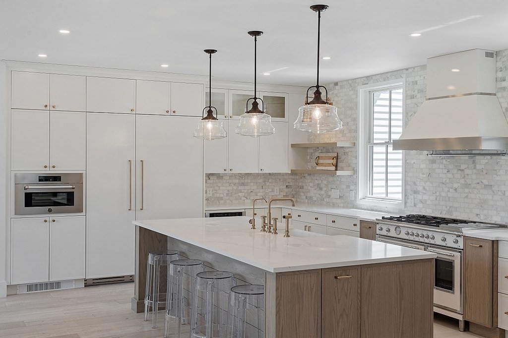 66 Spencer Brook Road Concord, MA 01742 - Photo 10 of 37 a kitchen with stainless steel appliances granite countertop a sink a counter space appliances and cabinets