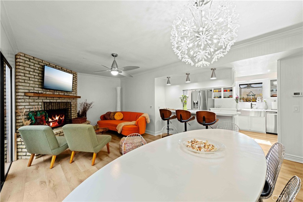86 North Vía Di Roma Walk Long Beach, CA 90803 - Photo 17 of 42 a view of a dining room with furniture a fireplace and chandelier