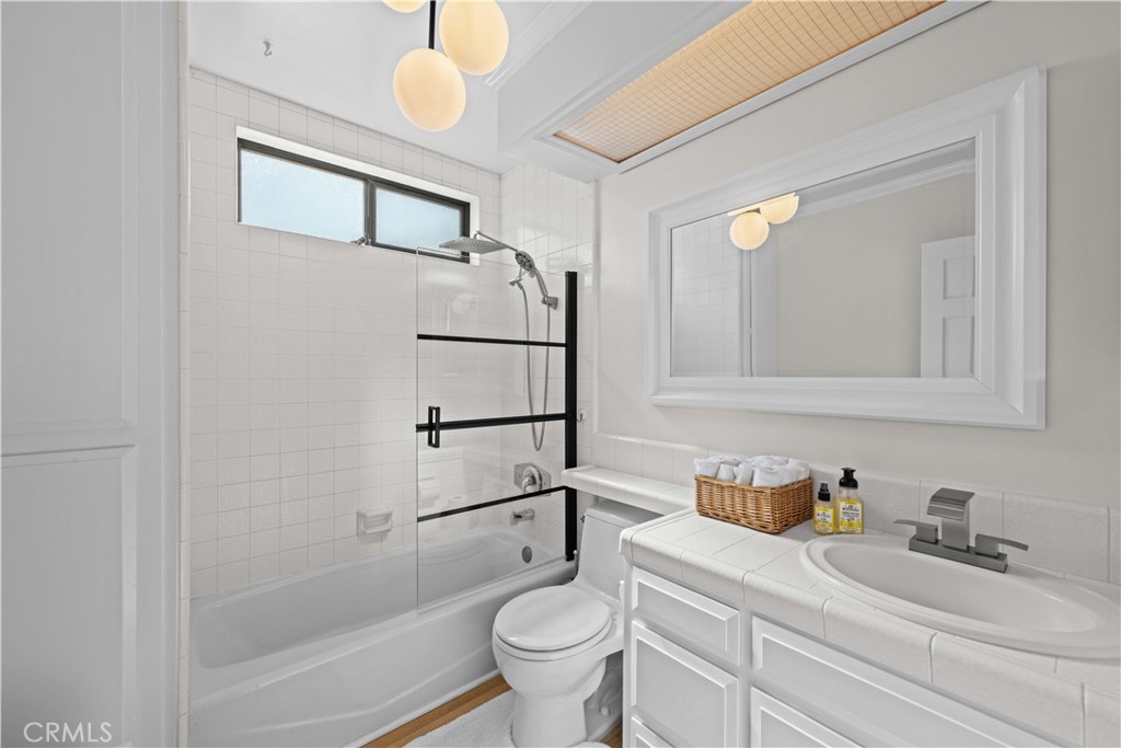 86 North Vía Di Roma Walk Long Beach, CA 90803 - Photo 29 of 42 a bathroom with a granite countertop sink mirror vanity and toilet