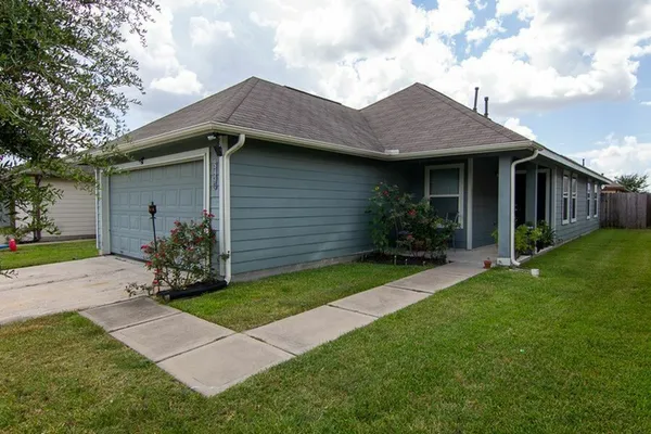 a backyard of a house with potted plants and a large tree