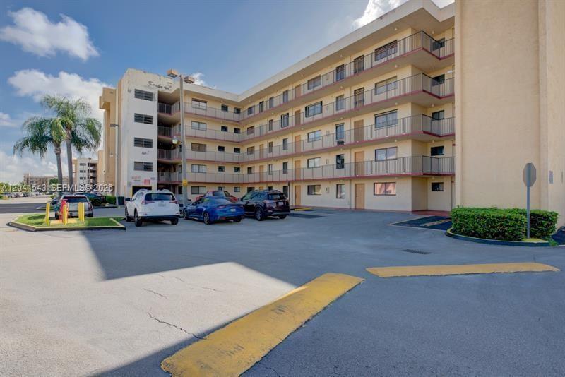 9915 West Okeechobee Road, Unit 2404 Hialeah Gardens, FL 33016 - Photo 1 of 5 front view of a building and a yard