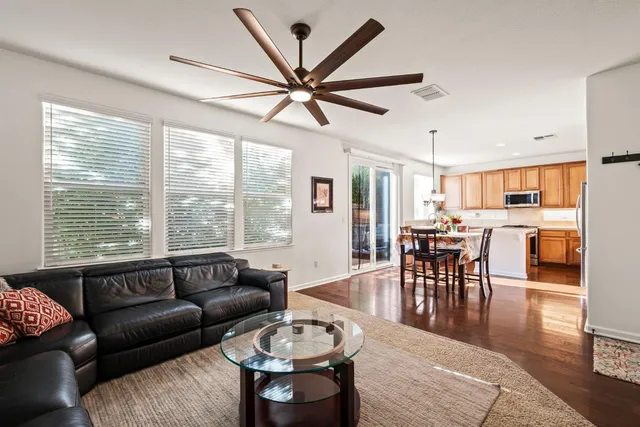 a living room with furniture a window and a dining table