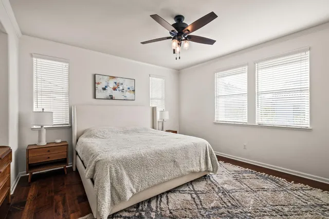 a bedroom with a large bed and a window
