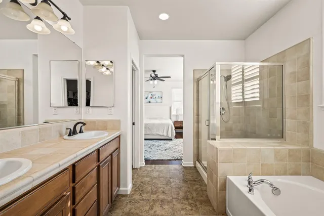 a bathroom with a tub sink and mirror